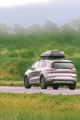 Fototapeta premium Spacious MPV family car driving on country road