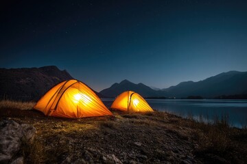 Two illuminated tents glow near a lake under a starry night sky, with mountain backdrop