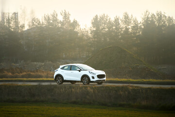 Fototapeta premium Crossover vehicle driving in sunlight