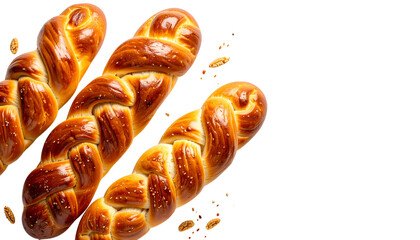 Golden braided bread with sesame seeds, close-up on black background with scattered seeds