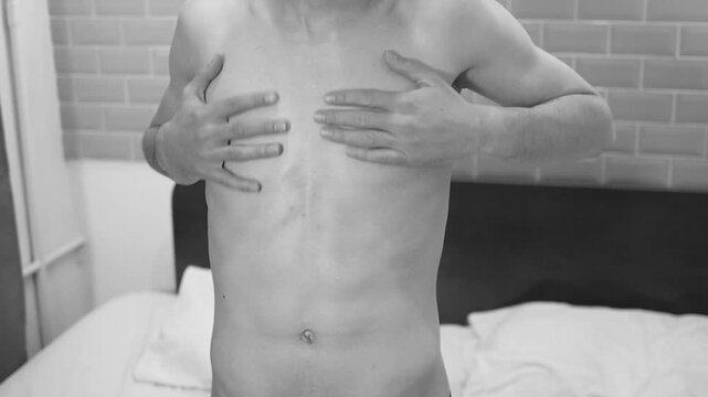 Male beauty. A man caresses his body.