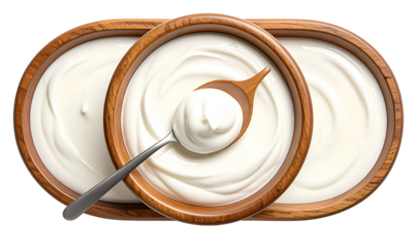 Three wooden bowls filled with creamy, white dairy product, one being scooped by a spoon