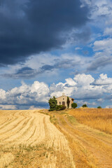 Fototapeta premium Rural chapel standing alone under dramatic sky in Provence, France