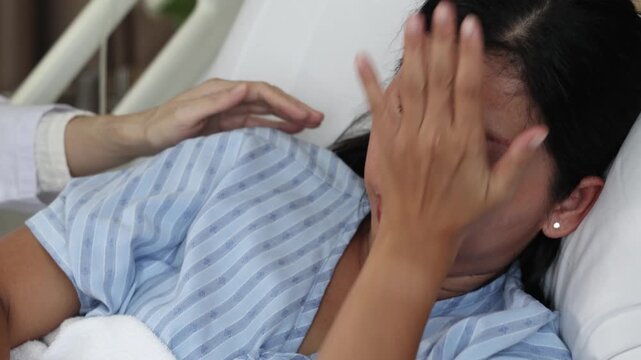Mental Healthcare. Emotional female patient crying and stress on hospital bed. Cry and receiving comfort from doctor. Caring support and human connection in difficult medical situation. Mental Health