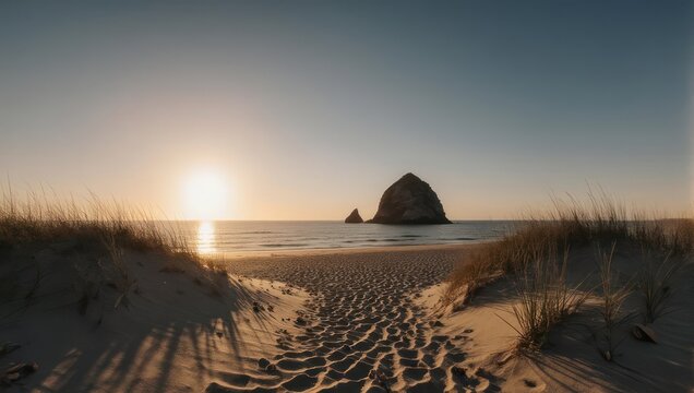 Sandy beach path leading to the ocean, with large rock formation at sunset - Powered by Adobe
