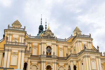 Fototapeta premium Radkow church facade with clock, domes, and ornate gold decorations