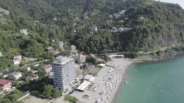 Aerial view of the Kvariati coastline in Adjara, Georgia, featuring seaside resorts, green hills, and the calm Black Sea. Peaceful coastal landscape with hotels, shoreline, and mountain backdrop