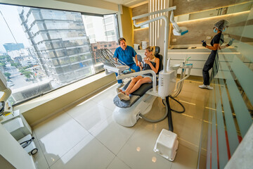 Young woman visiting dentist office for dental preventive treatment