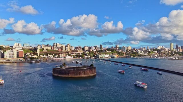 Aerial View of Fort S&atilde;o Marcelo and Salvador Waterfront, Brazil. Drone footage capturing Salvador harbor with Fort S&atilde;o Marcelo, small boats, and the coastal urban skyline in northeastern Brazil.