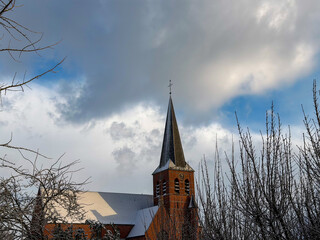 Snowy Church Steeple Under Cloudy Sky