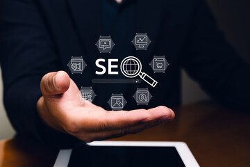 A hand holds digital icons representing SEO strategies and analytics, highlighting the importance...