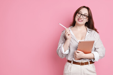 Designer with tablet on pink background, space for text