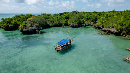 Traditional boat in turquoise waters of Zanzibar lagoon
