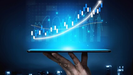 A hand holds a tablet that showcases a vibrant digital financial graph with an upward trend, symbolizing data analysis and growth in a modern financial context. Copula