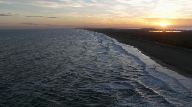 Aerial drone footage of a Mediterranean sandbar separating coastal lagoons and the sea near S&egrave;te, Marseillan, and Agde in southern France.