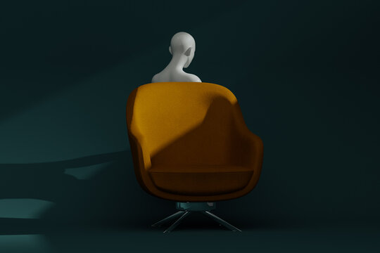 A mannequin is placed in an armchair with a dark background