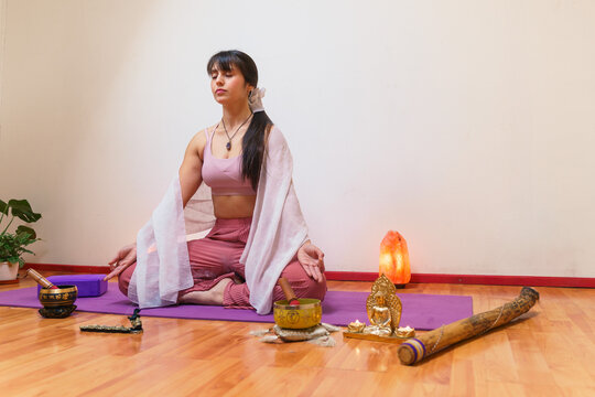 Woman meditating in peaceful yoga setting