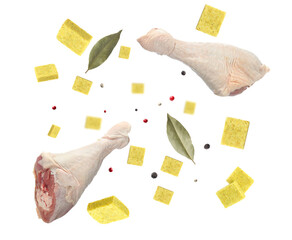 Bouillon cubes, chicken drumsticks, dry bay leaves and peppercorns flying in air on white background