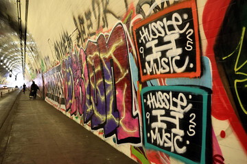 Fototapeta premium Los Angeles, California – November 21, 2025: Iconic 2nd Street Tunnel under Bunker Hill covered with graffiti, famous filming location featured in movies and TV productions, Downtown Los Angeles 