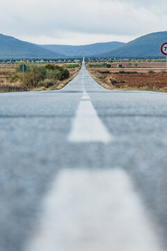 Endless road through open fields and infinite horizon