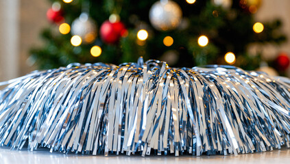 Shiny Blue and Silver Tinsel Pom Pom with Christmas Tree Background