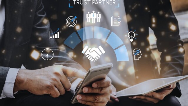 Hands holding mobile device with business icons and partnership concept, emphasizing trust, strategy, success, and innovation in professional relationships Gluon. - Powered by Adobe