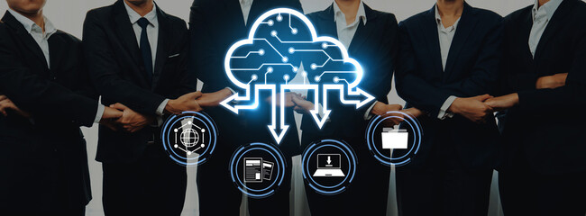 A professional business team stands together while engaging with cloud technology concepts, showcasing digital icons that represent data management and networking solutions. Trope