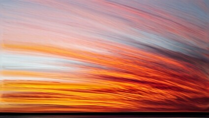 Abstract colorful sunset with streaks of orange and red light in the sky