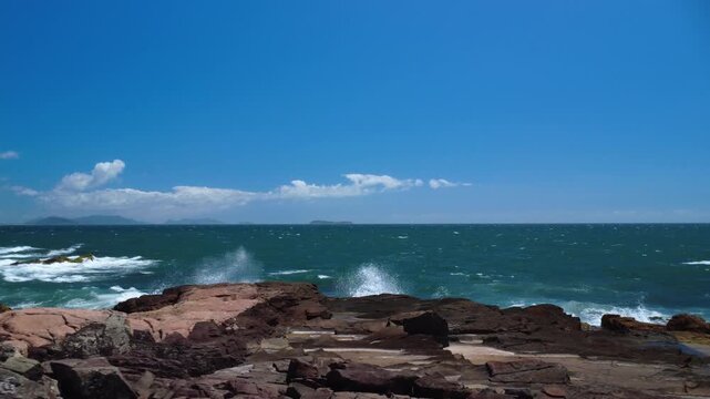 Turquoise Waves Crashing on Rocky Coastline &ndash; Garopaba, Brazil aerial drone shot