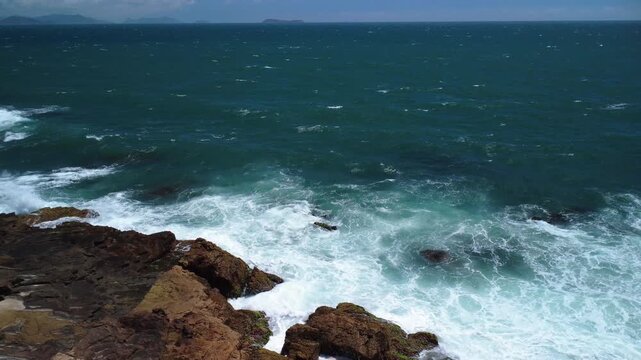 Turquoise Waves Crashing on Rocky Coastline &ndash; Garopaba, Brazil aerial drone shot