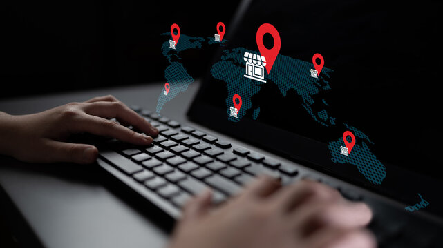 Close-up of hands typing on a keyboard with a digital world map in the background, featuring location pins and a shop icon representing global business and e-commerce opportunities. Gantry - Powered by Adobe