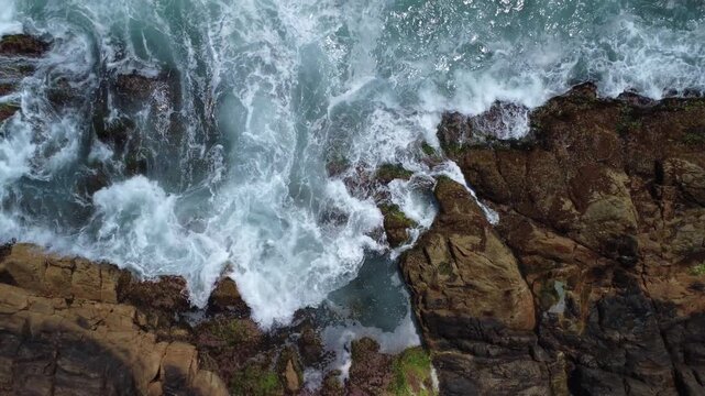 Turquoise Waves Crashing on Rocky Coastline &ndash; Garopaba, Brazil aerial drone shot