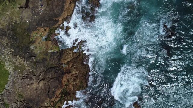 Turquoise Waves Crashing on Rocky Coastline &ndash; Garopaba, Brazil aerial drone shot