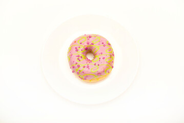 One sweet donut on a plate. A delicious sweet snack. An American doughnut.