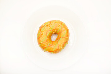 One sweet donut on a plate. A delicious sweet snack. An American doughnut.