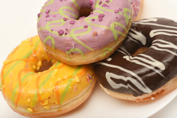 Sweet donuts on a plate. A delicious sweet snack. An American doughnut.