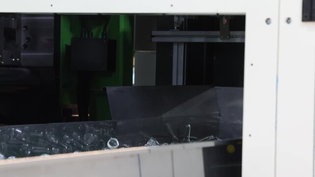 Plastic bottle preforms. Making of Transparent PET plastic preforms move along automated conveyor belt in factory. Industrial production line concept for plastic bottle packaging automation recycling