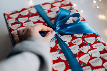 Gift giving concept with hand and festive atmosphere.
