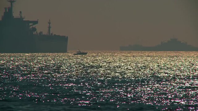 Back light Shimmering Sea With Silhouetted Ships and Seagulls