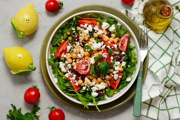 Salad with chickpeas, feta, cherry tomatoes and arugula .selective focus