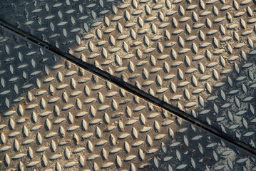 Top view of rusty diamond plate metal floor texture. Anti-slip steel industrial surface background with diagonal line.
