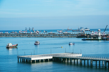View of a commercial shipping port in the morning. Maritime transportation and logistics.