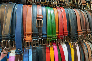 Close-up of men's leather belts made in Italy, for sale at a street market