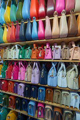 Close-up of women's leather handbags made in Italy, for sale at a street market