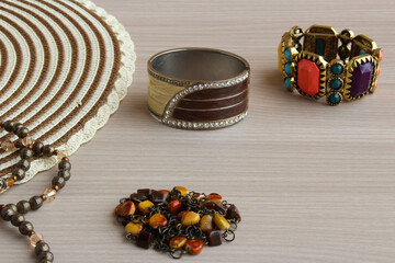 Set of bracelets on a wooden background. Horizontal shot with copy space, perfect for female fashion themes, costume jewelry content and lifestyle.