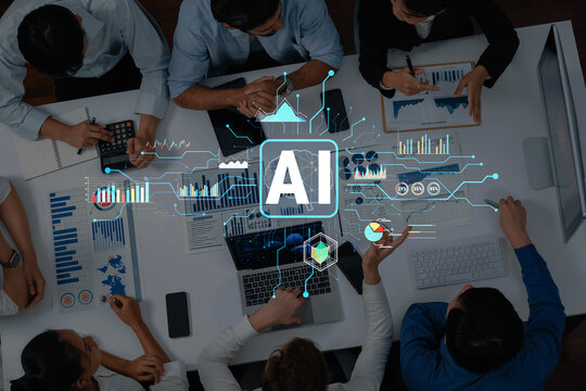 A business team gathers around a table to collaborate on an artificial intelligence project, utilizing data analysis and digital tools in a modern office setting. Trope - Powered by Adobe