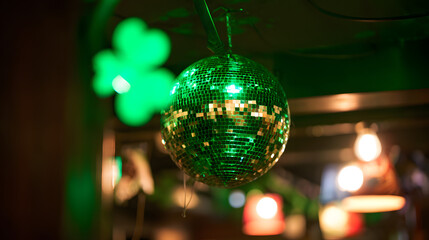 Green disco ball hangs in a festive setting during an evening celebration with lights and decorations