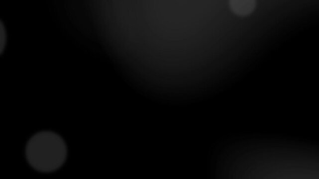 Abstract black and white bokeh background with soft light leaks
