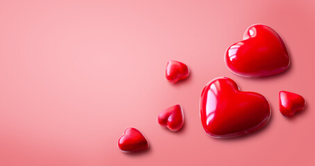 Red Glossy Hearts on Pink Background: Romantic Valentine's Day Concept