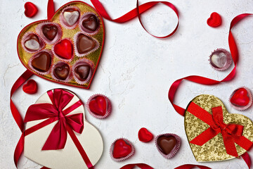 Valentine's Day Heart-Shaped Chocolate Boxes with Red Ribbons on Light Background